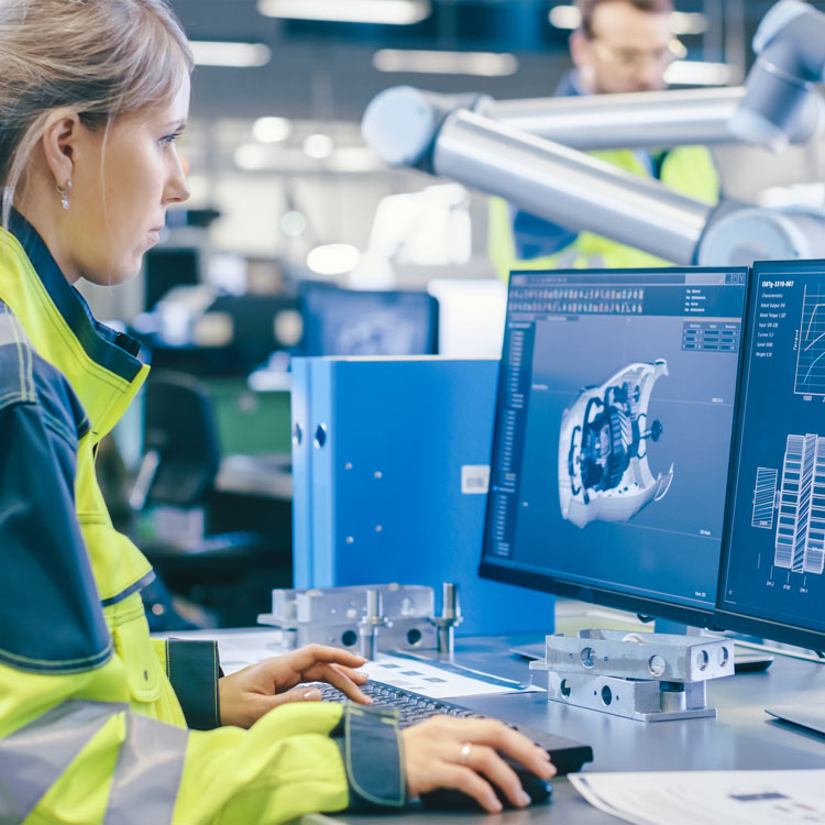 Factory engineer inspecting a 3D part model on screen