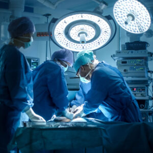Surgical team operating under theatre lights