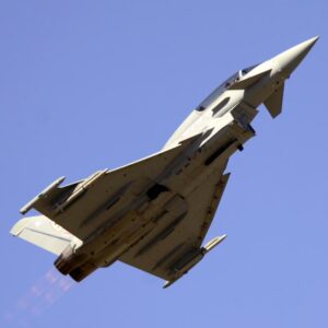 Fighter jet climbing against a clear blue sky