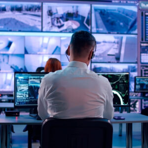 Security analyst monitoring CCTV feeds in a control room