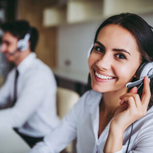 Smiling call centre agent wearing a headset